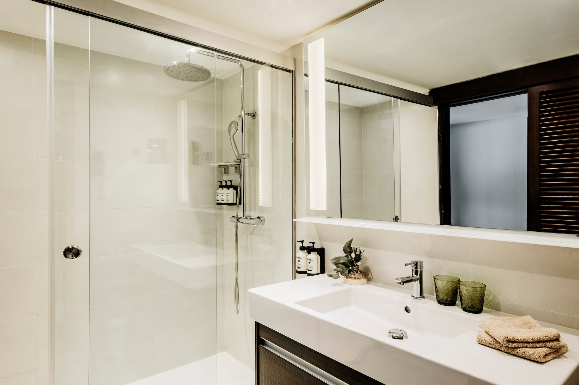 a bathroom with a shower and sink