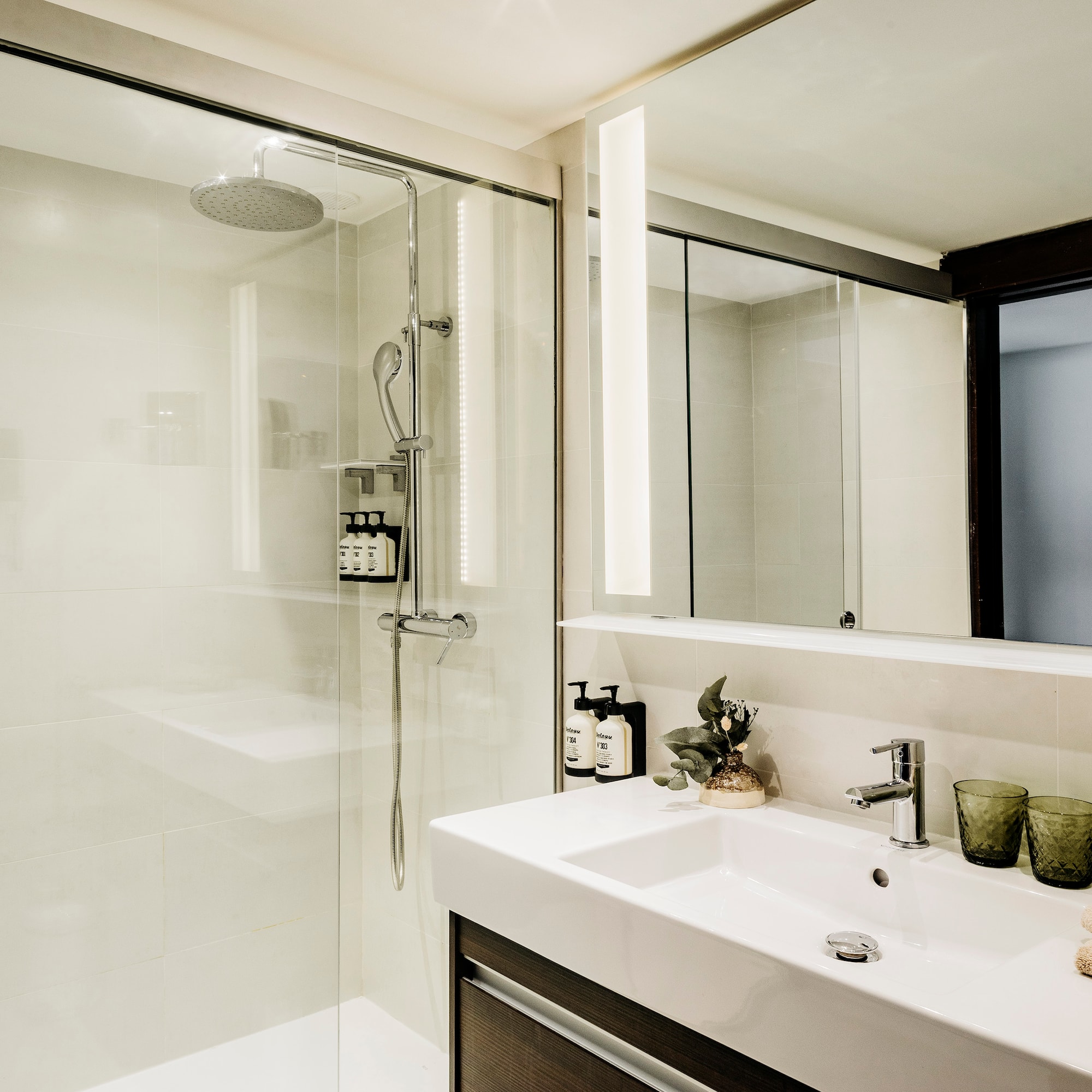 a bathroom with a shower and sink