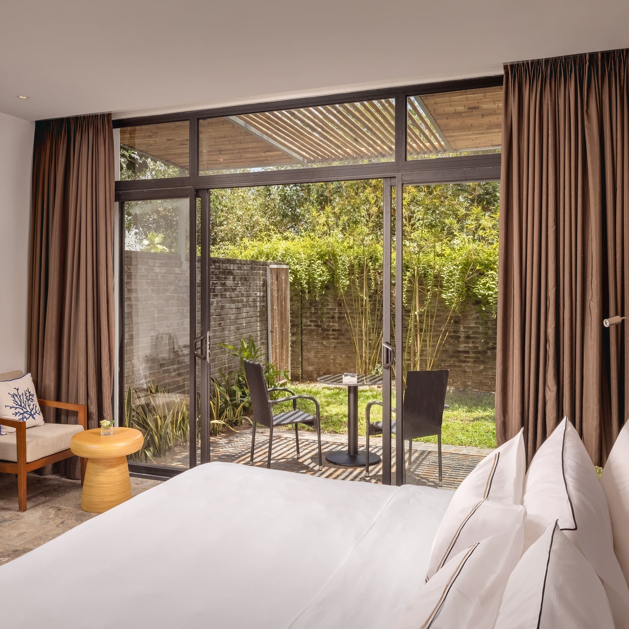 a bedroom with a glass door and a chair
