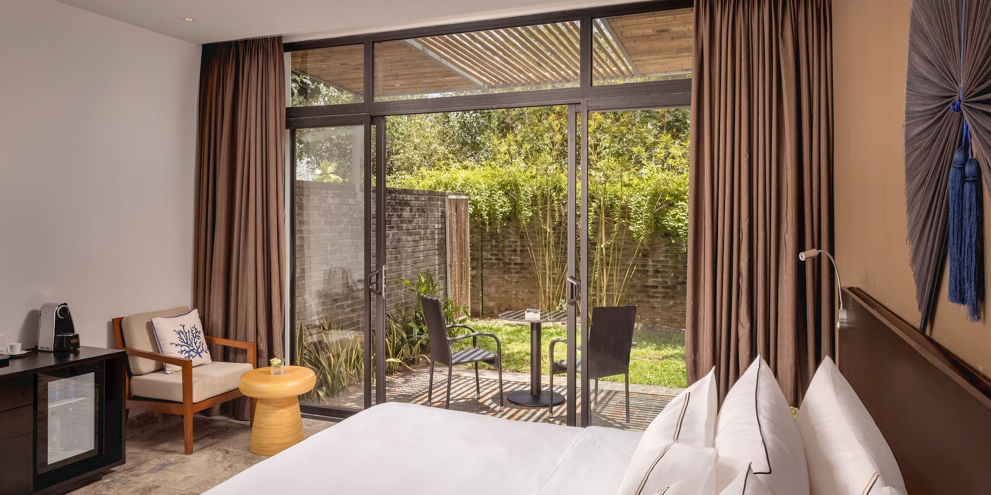 a bedroom with a glass door and a chair