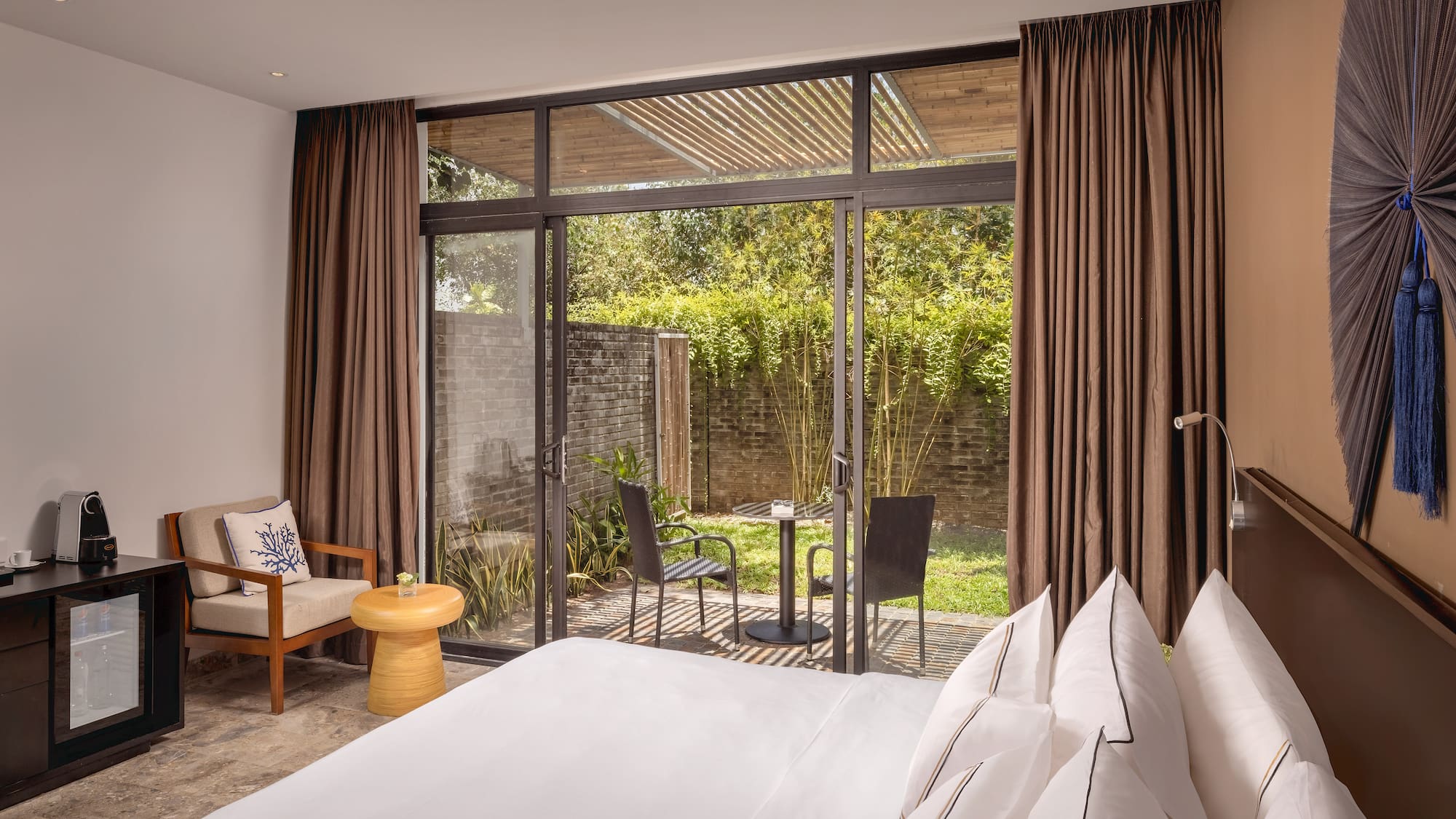 a bedroom with a glass door and a chair