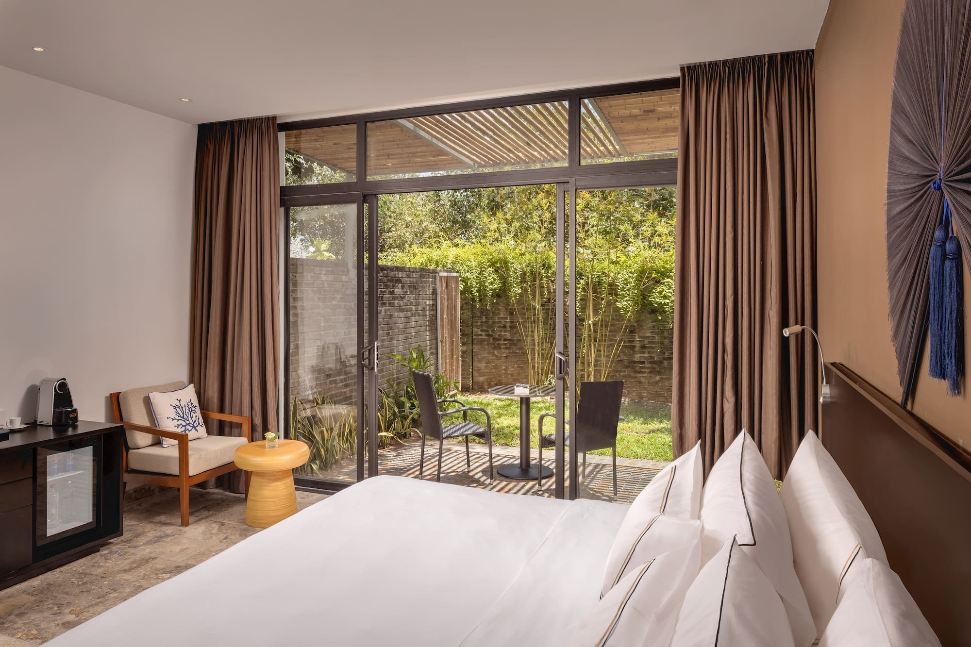 a bedroom with a glass door and a chair