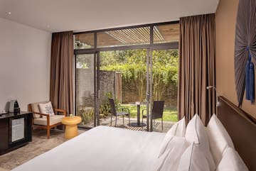 a bedroom with a glass door and a chair