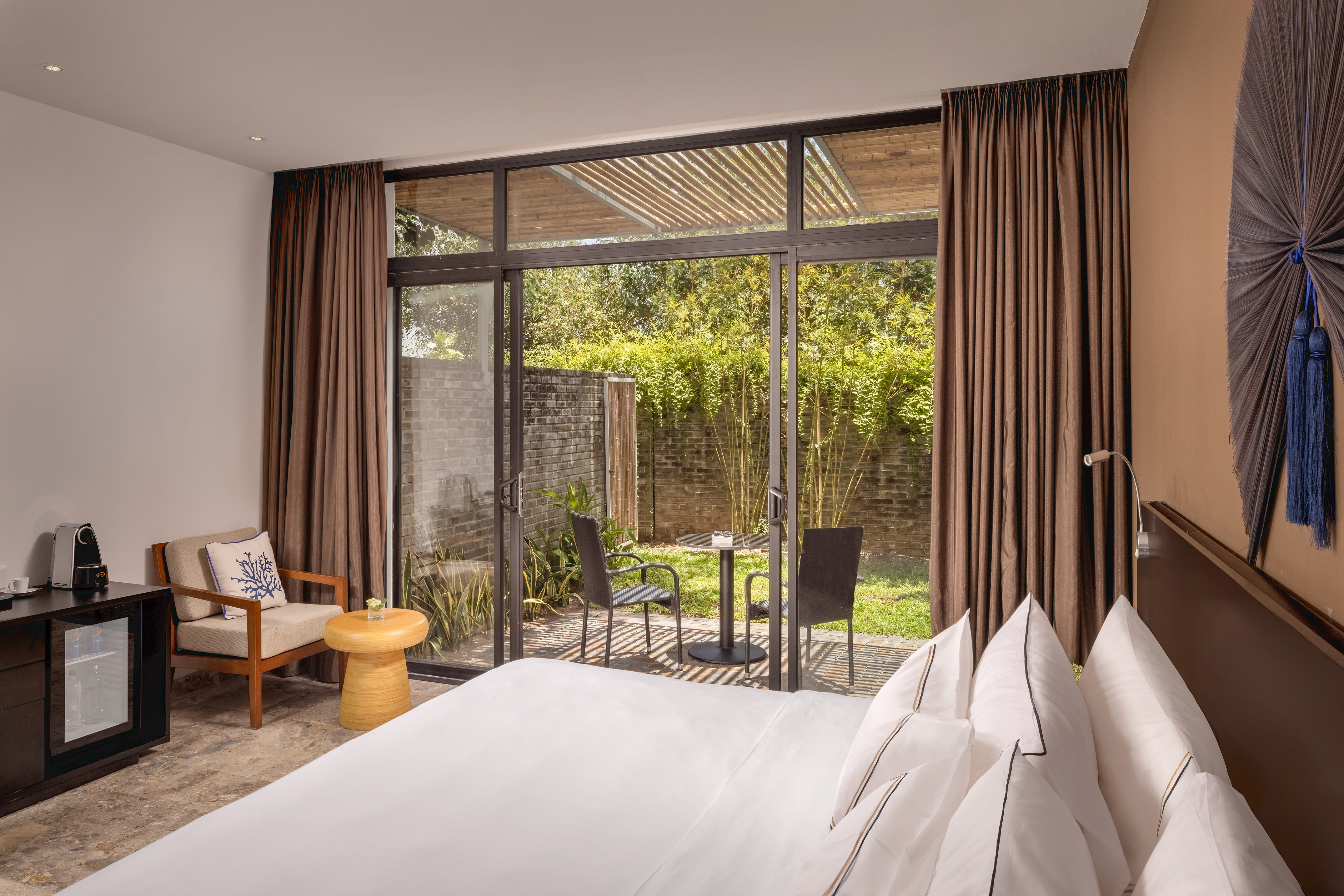 a bedroom with a glass door and a chair