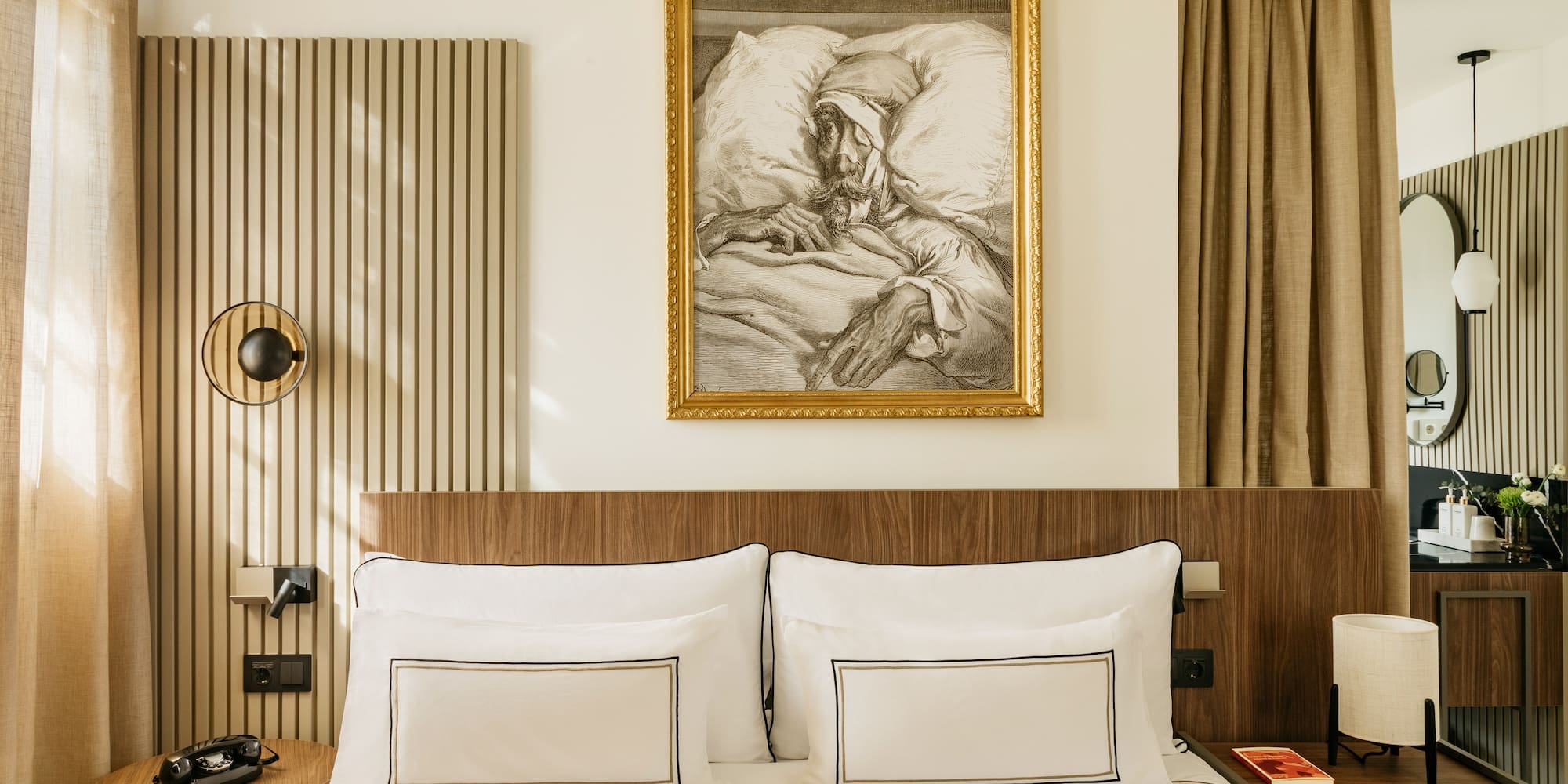 a bed with a painting on the wall