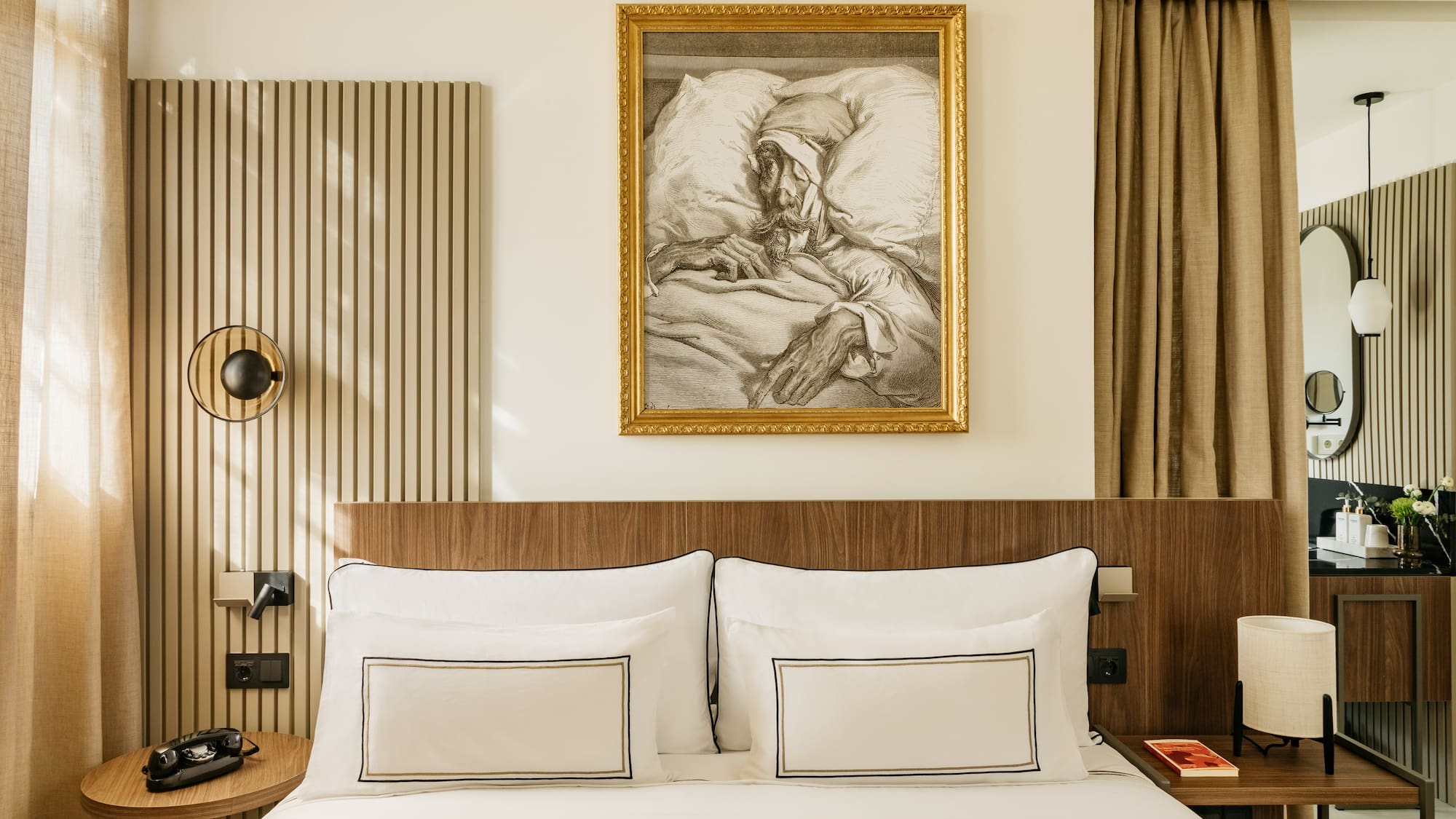 a bed with a painting on the wall