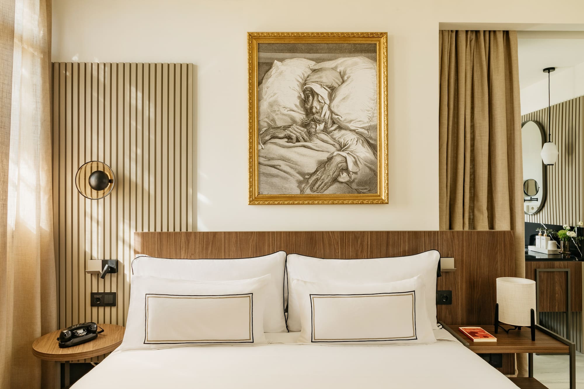 a bed with a painting on the wall