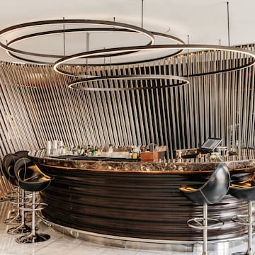 a bar with a round counter and chairs