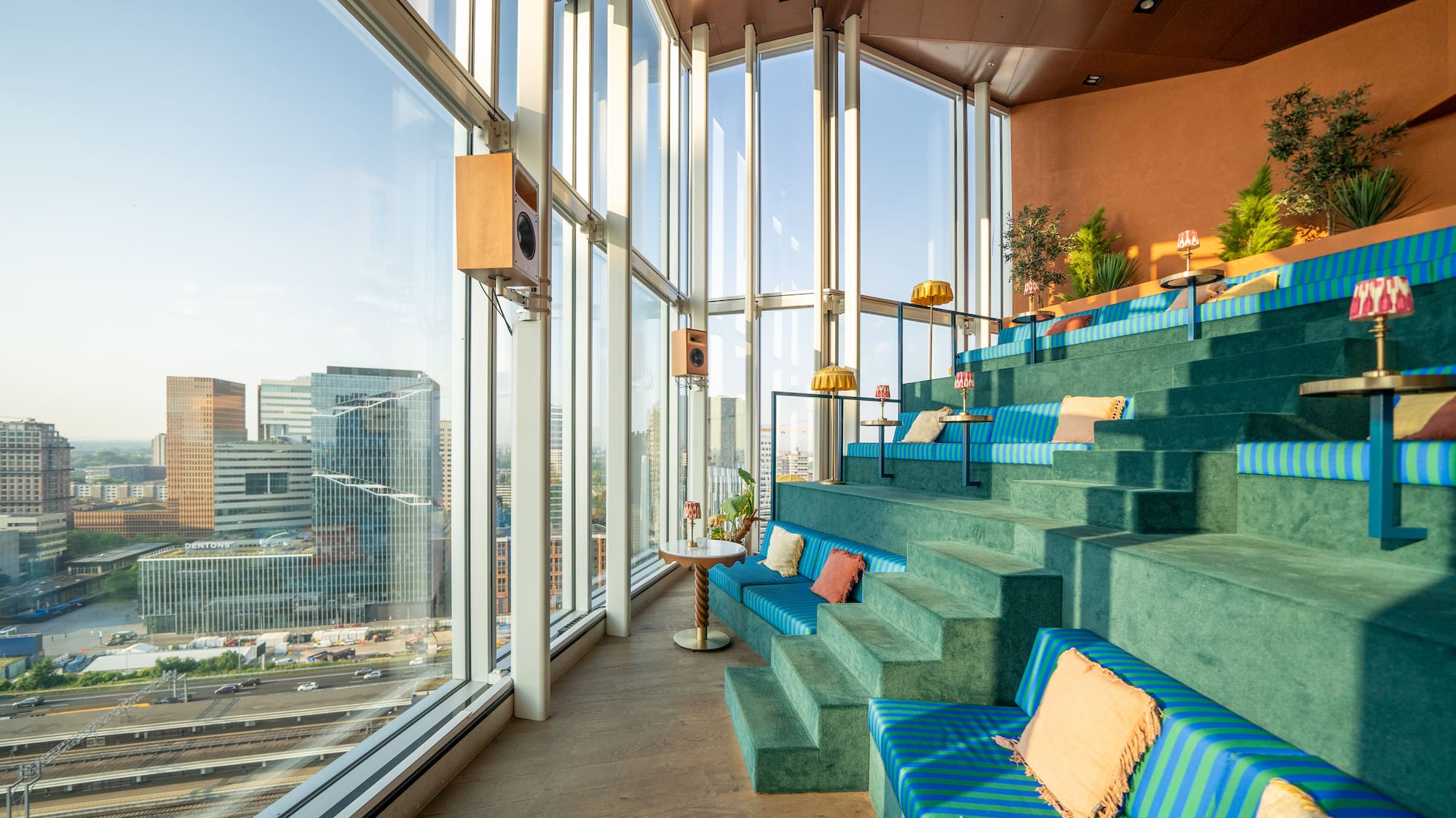 a blue and green seats in a room with large windows