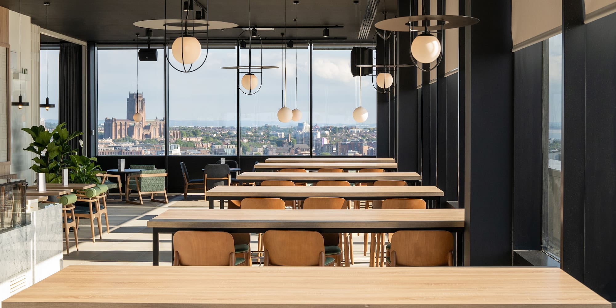 a room with tables and chairs and a view of a city