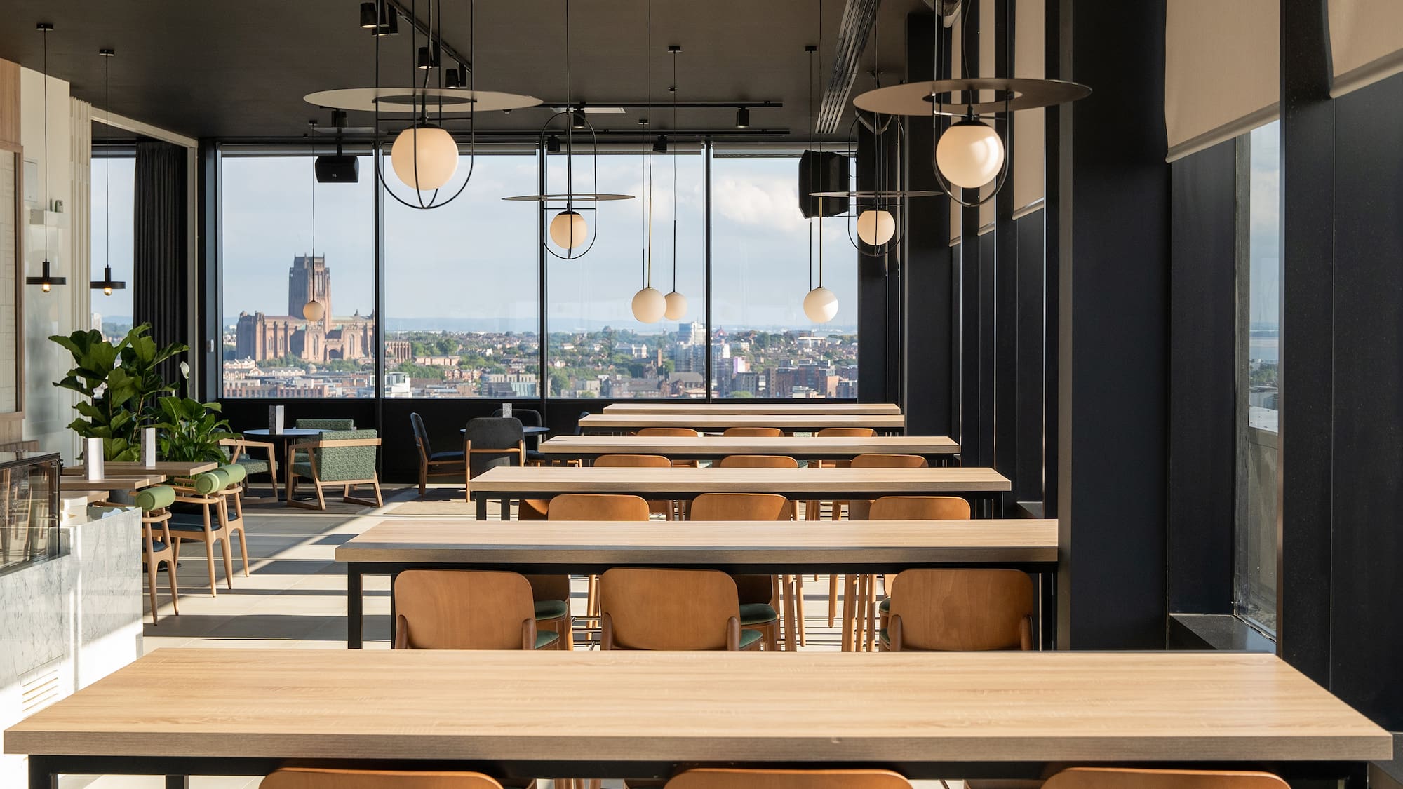 a room with tables and chairs and a view of a city