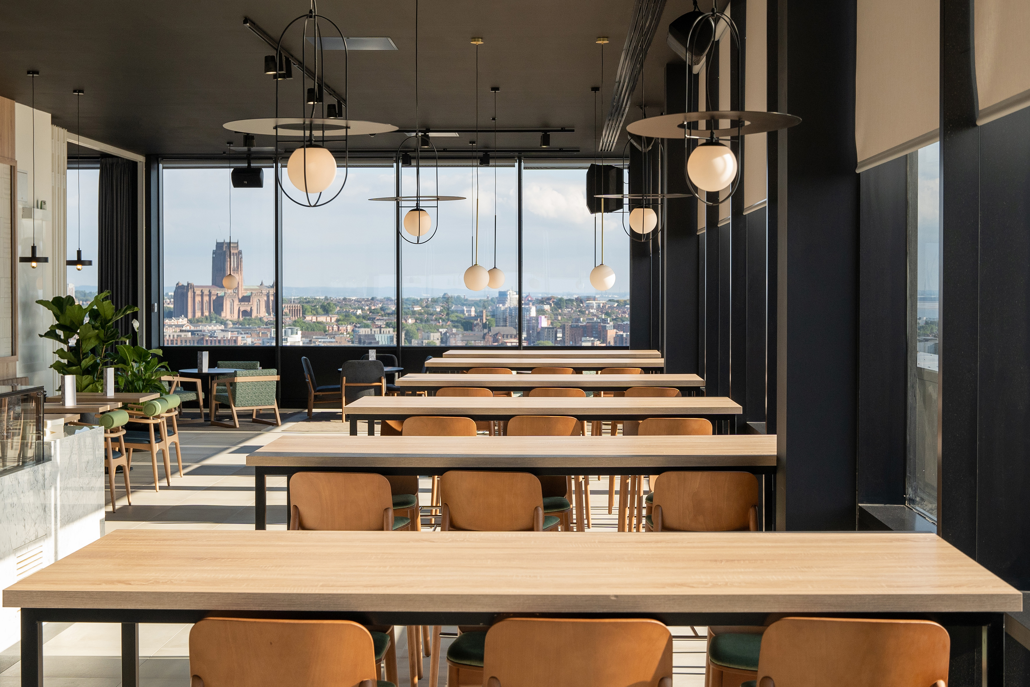 Modern restaurant with Liverpool city skyline view and cathedral.