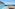 Rooftop infinity pool overlooking the ocean with sun loungers and blue sky.