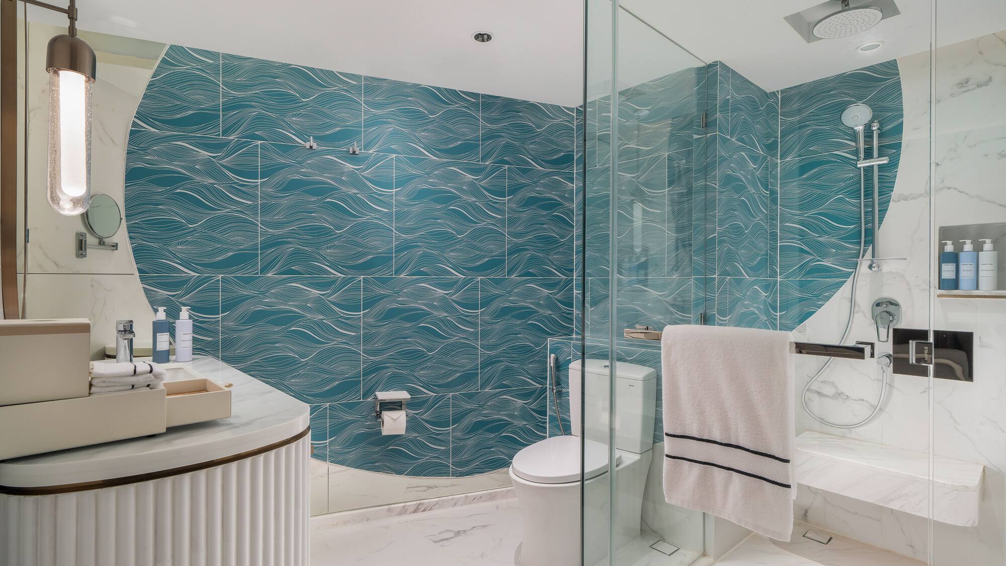 a bathroom with a blue wall and a toilet