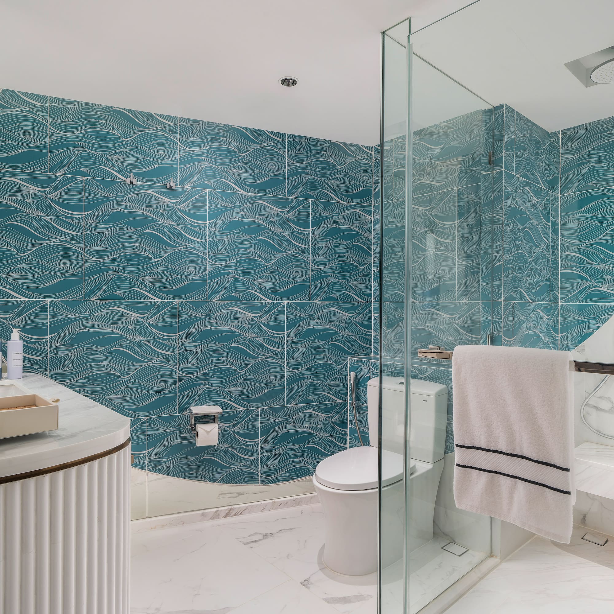 a bathroom with a blue wall and a toilet