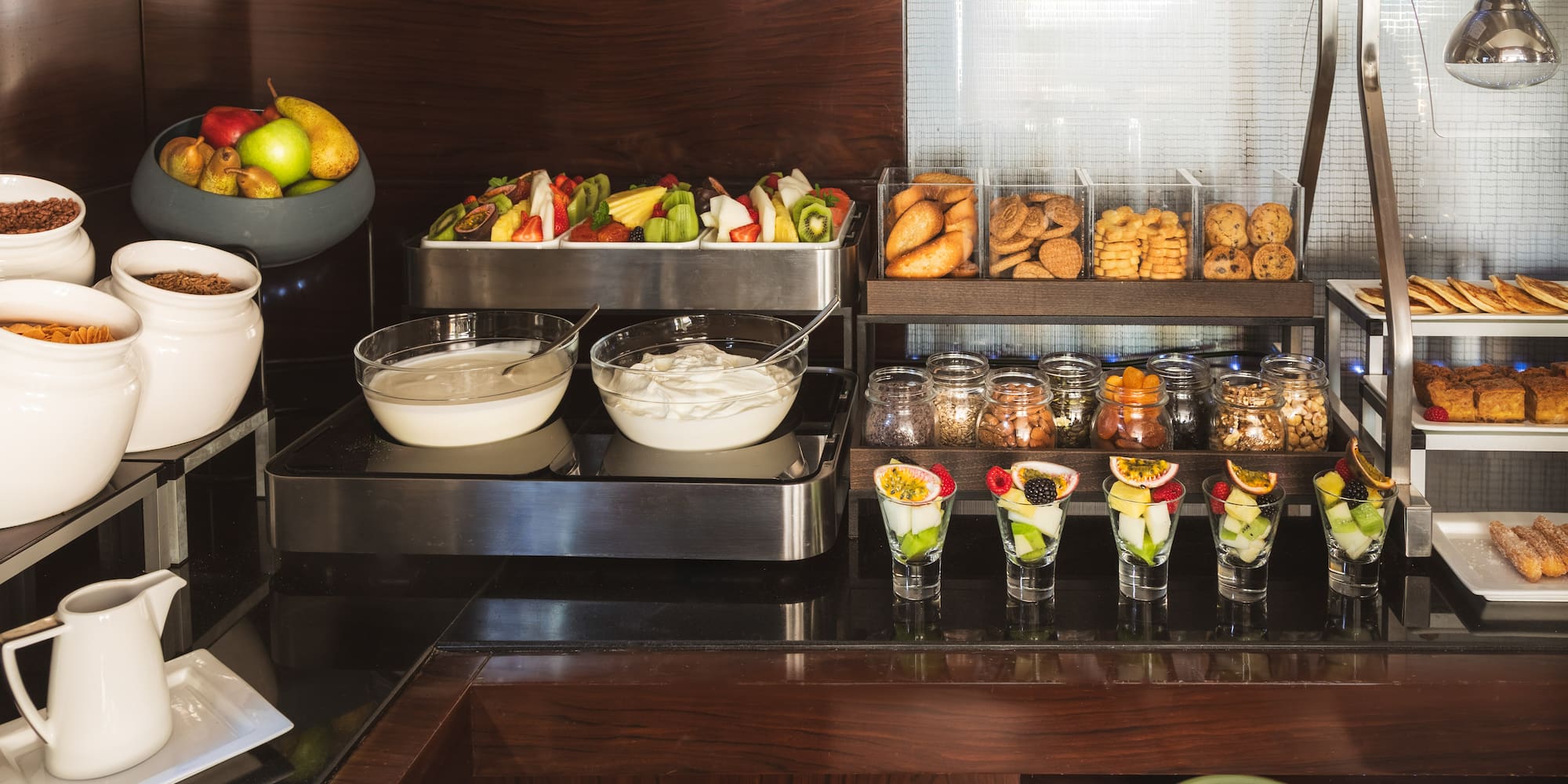 a buffet with fruit and desserts