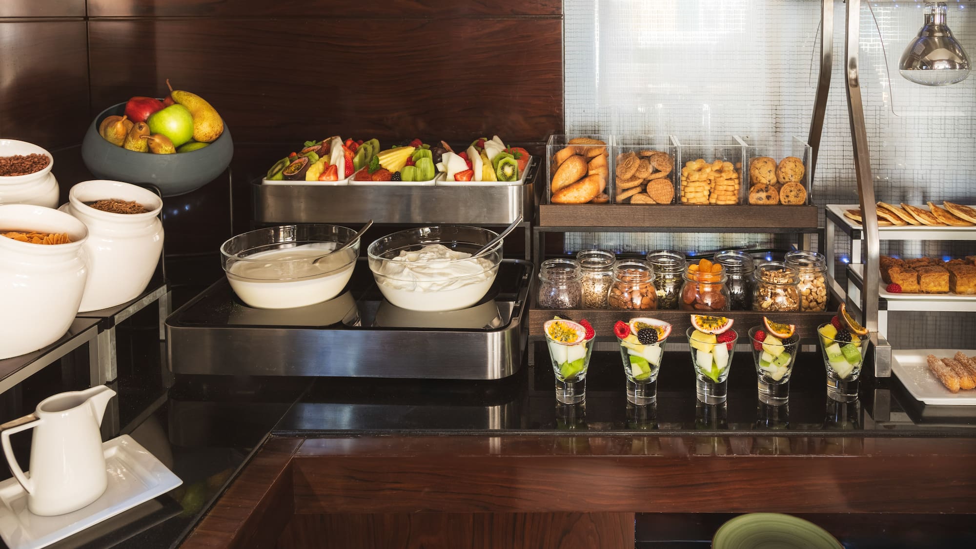 a buffet with fruit and desserts