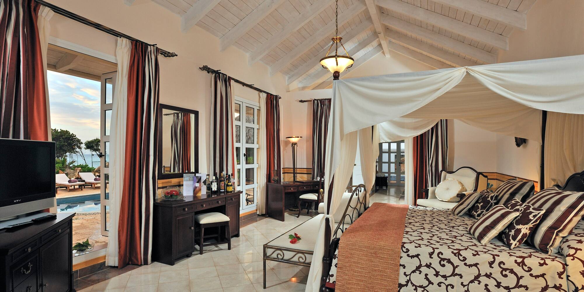 a bedroom with a canopy bed and a dresser