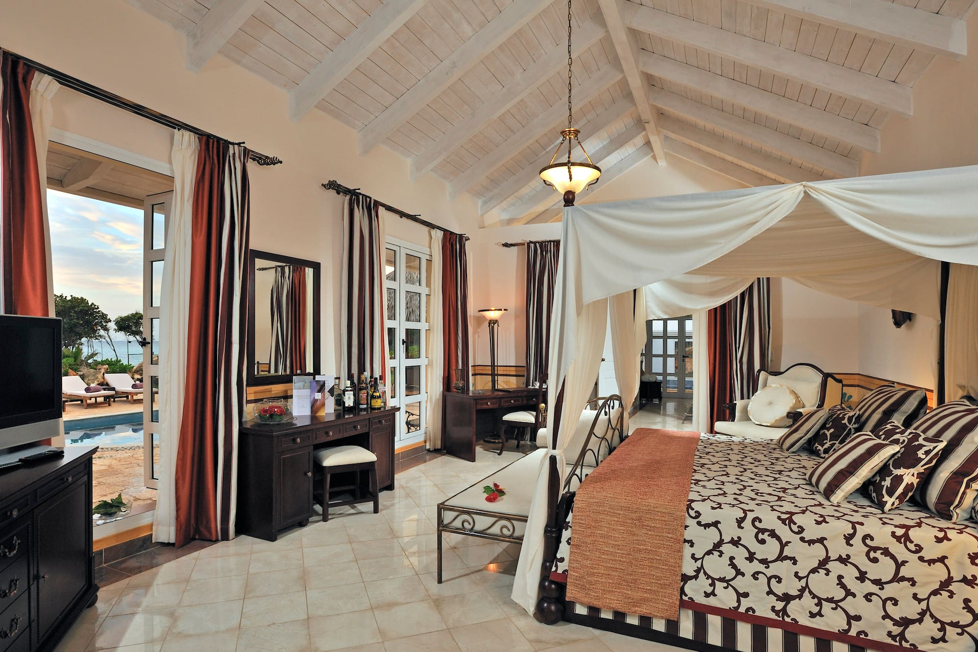 a bedroom with a canopy bed and a dresser