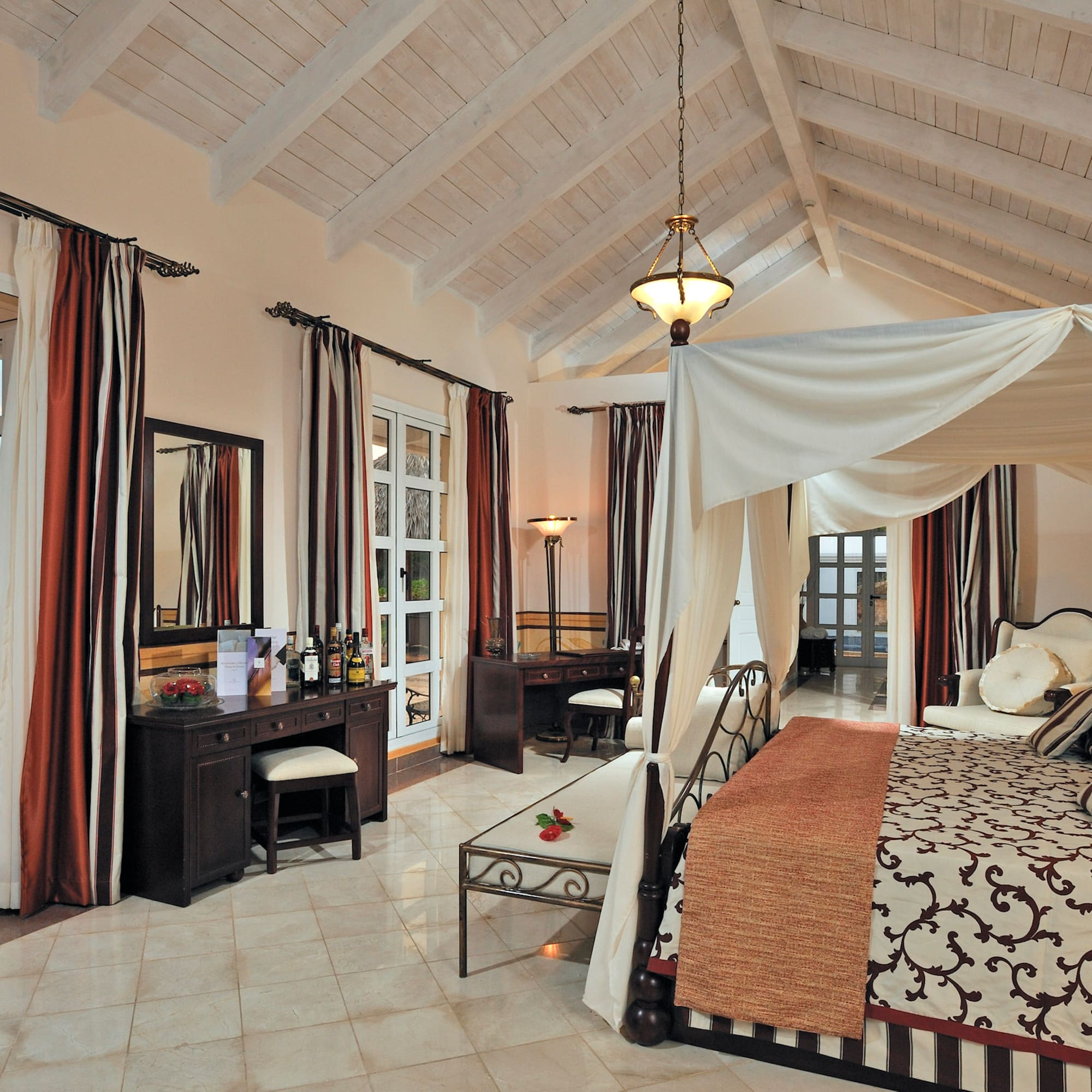 a bedroom with a canopy bed and a dresser