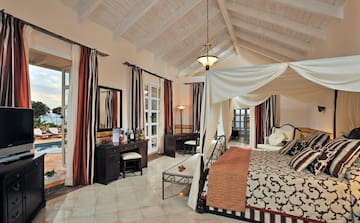 a bedroom with a canopy bed and a dresser