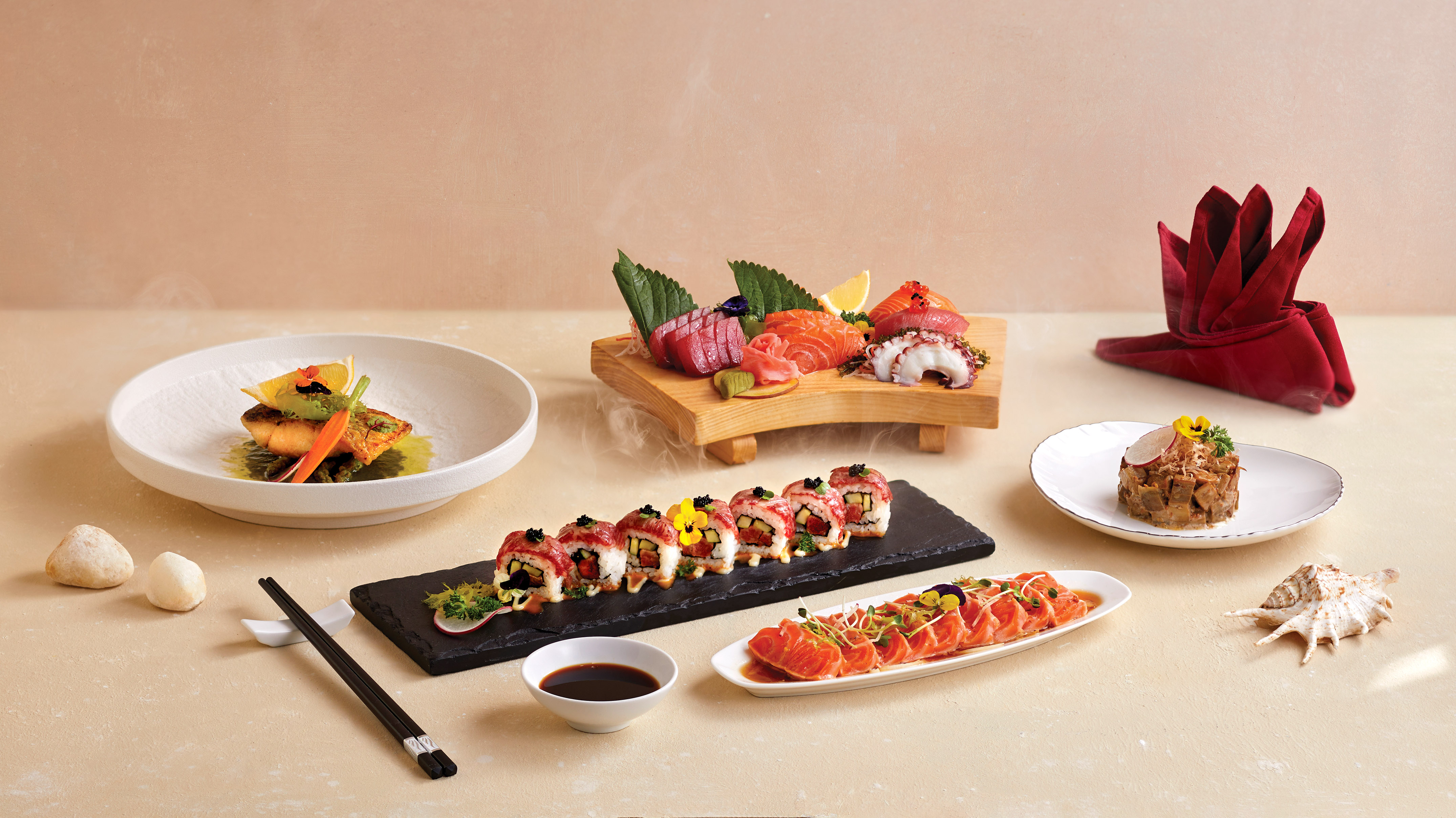 Japanese seafood spread with sashimi, sushi rolls, and grilled fish.