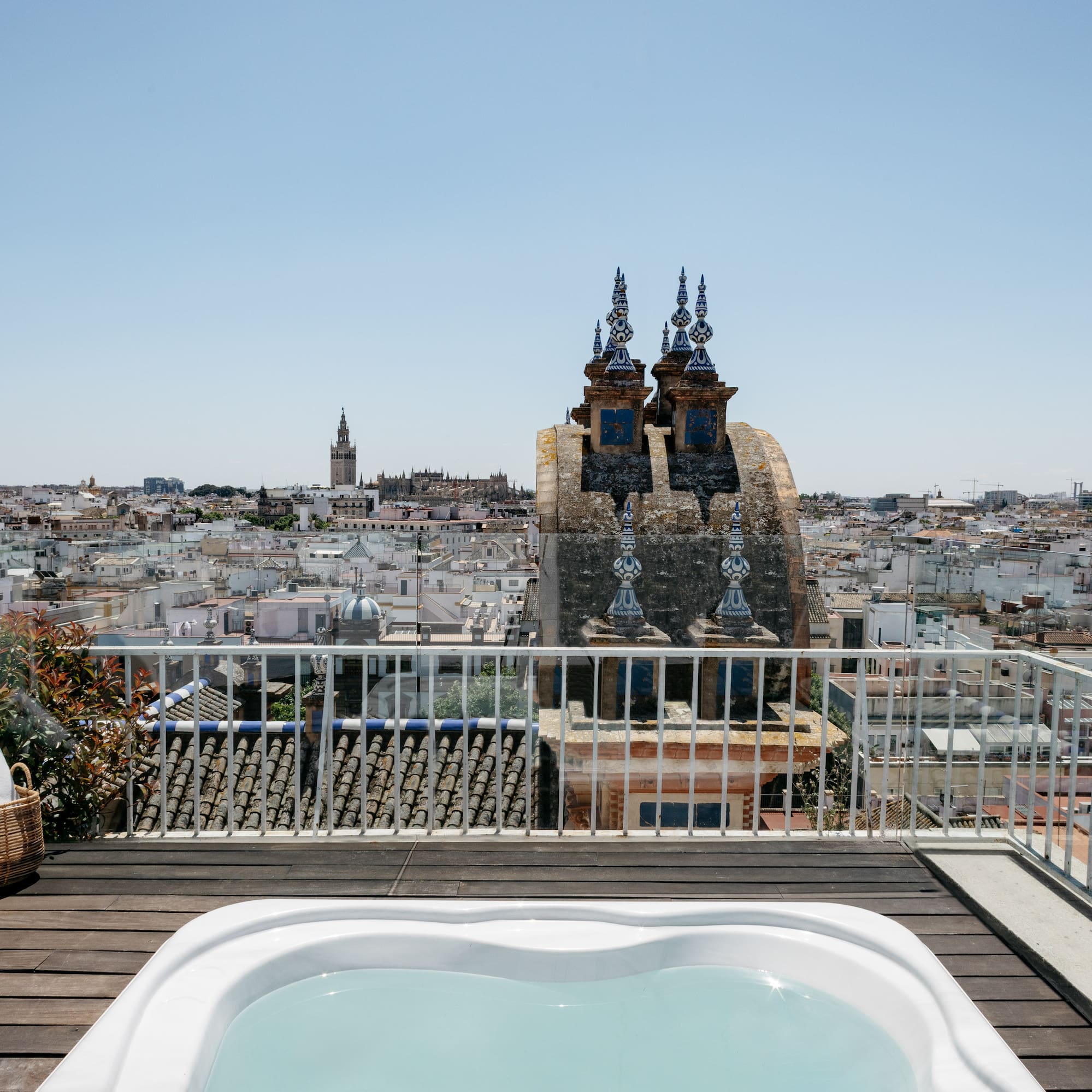 a hot tub on a rooftop overlooking a city