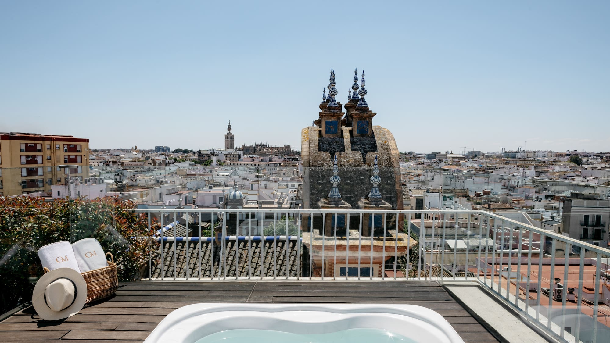 a hot tub on a rooftop overlooking a city