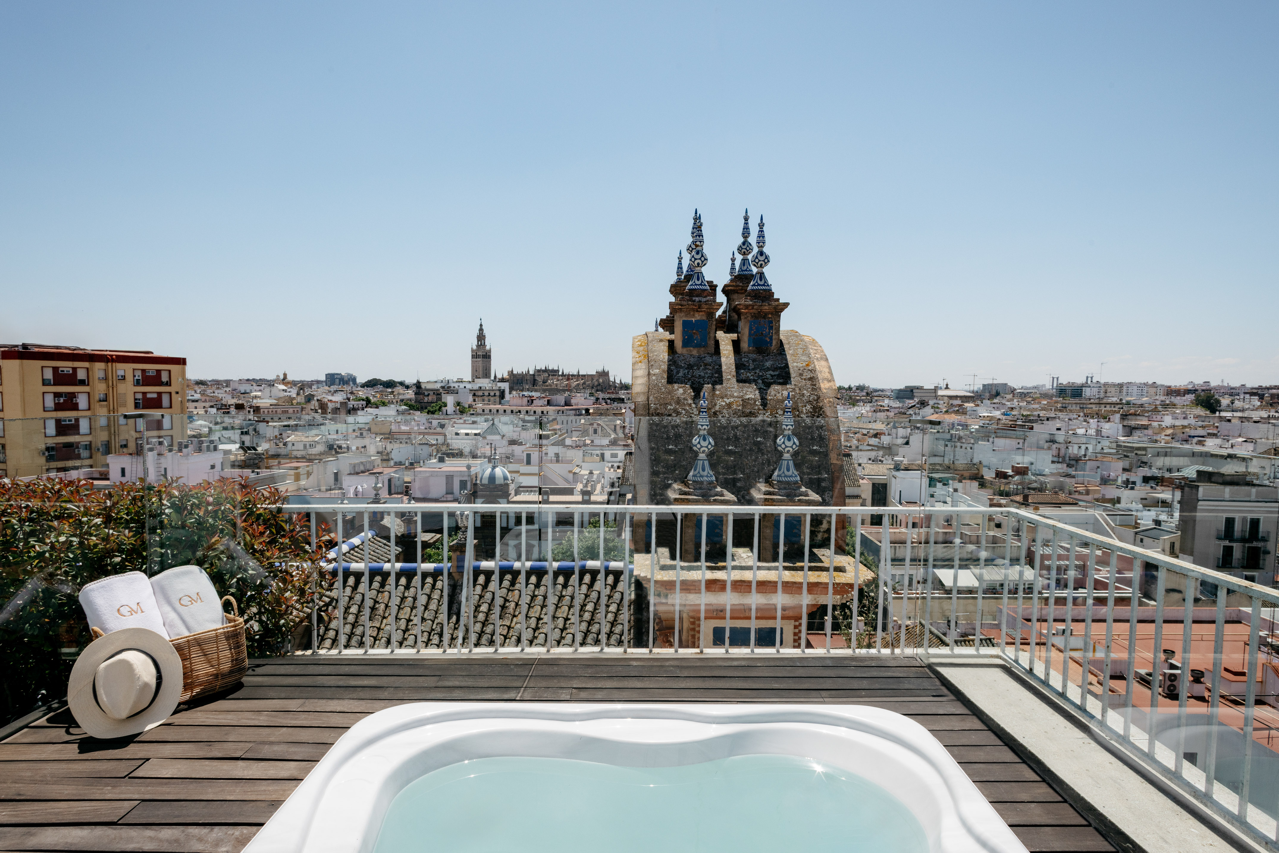 a hot tub on a rooftop overlooking a city