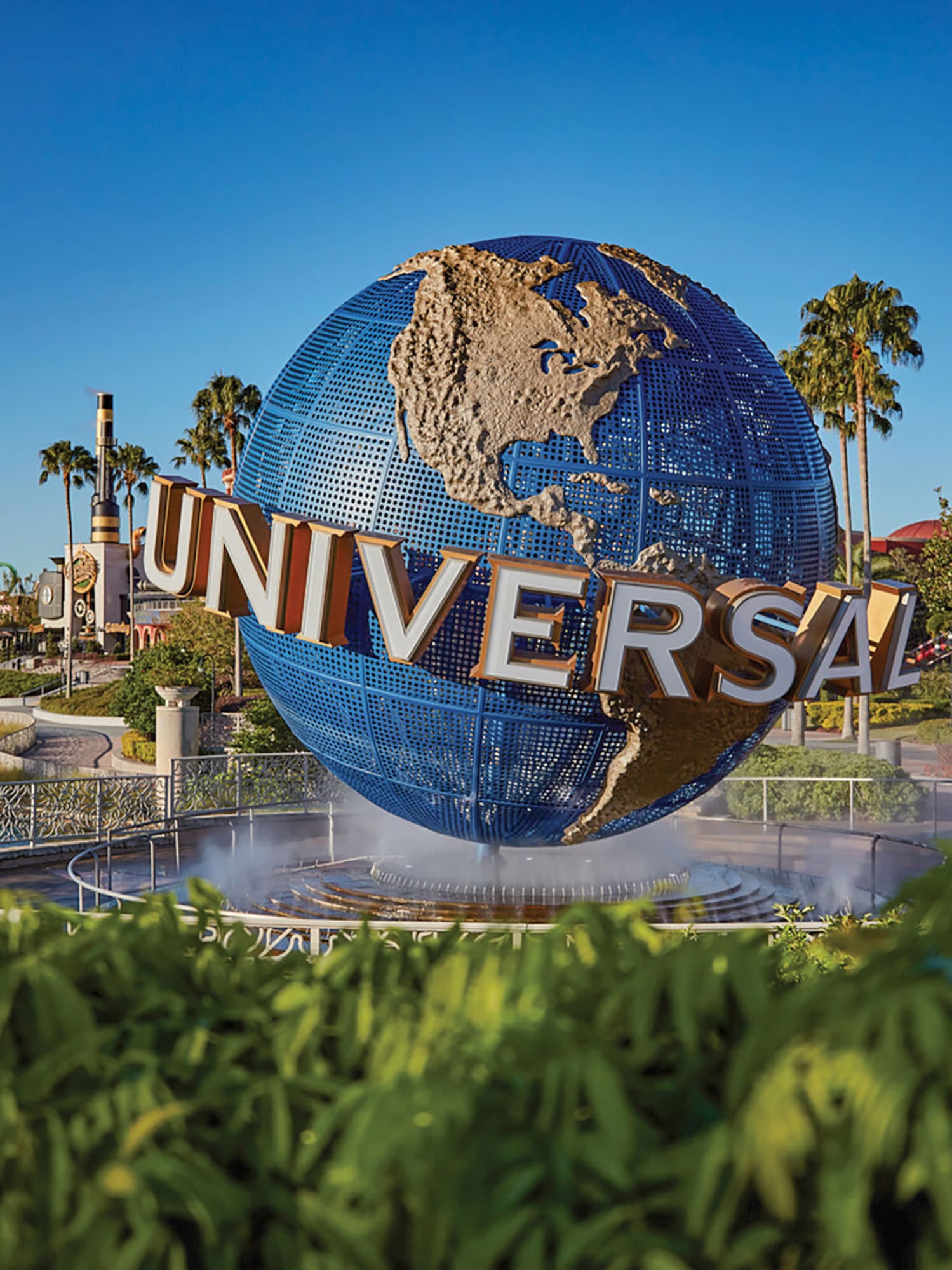 a large globe fountain with a sign on it