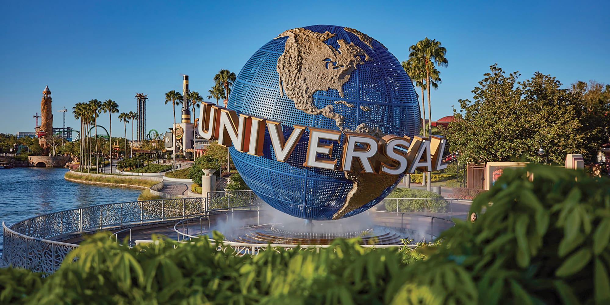 a large globe fountain with a sign on it