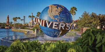 a large globe fountain with a sign on it