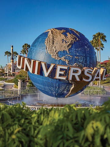 a large globe fountain with a sign on it