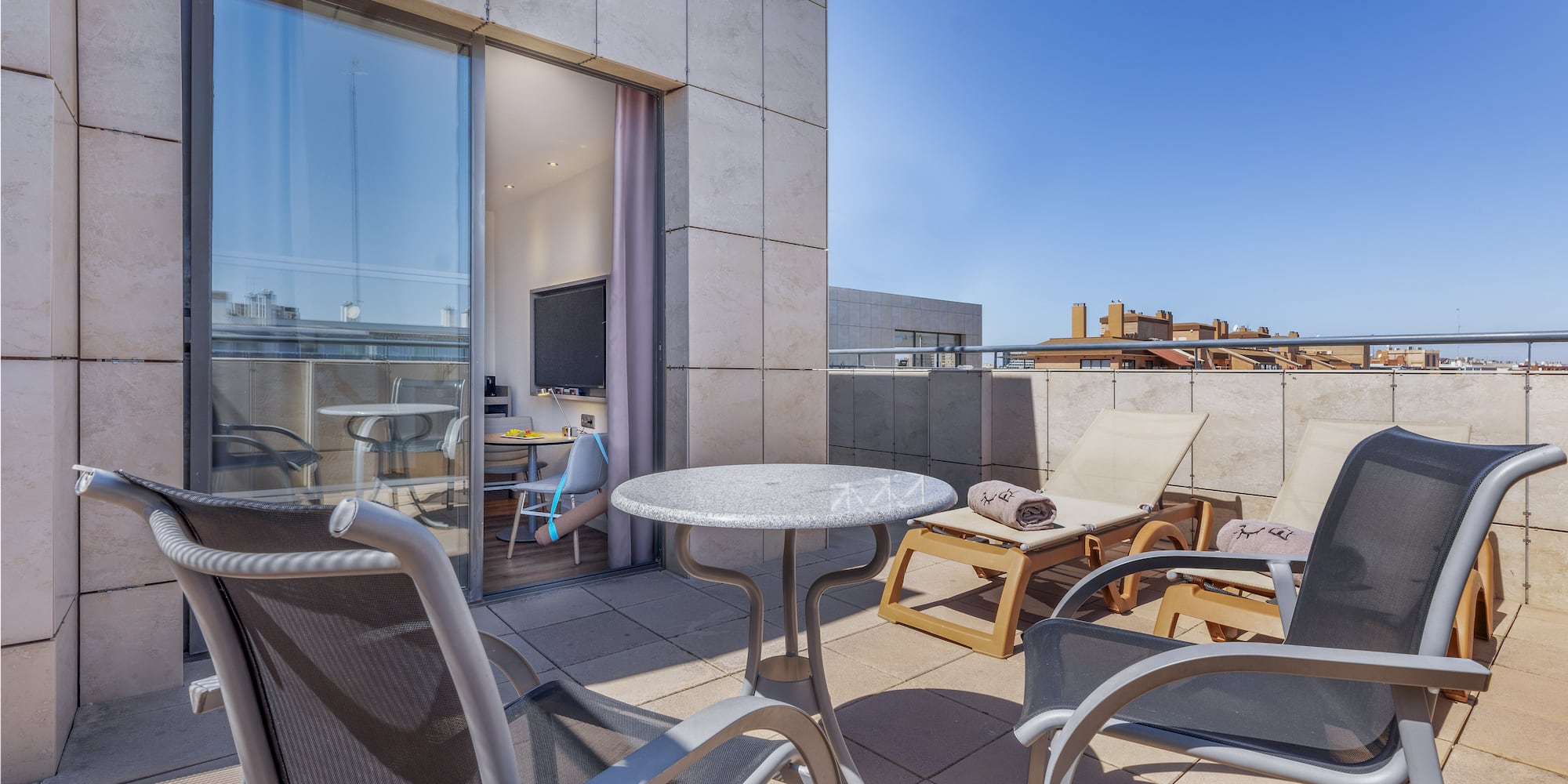 a patio with chairs and a table