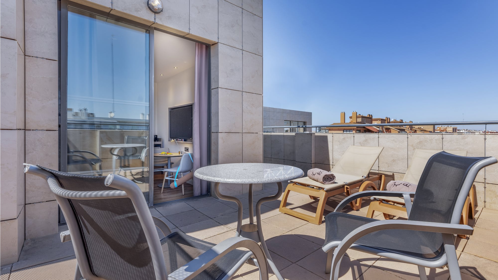 a patio with chairs and a table