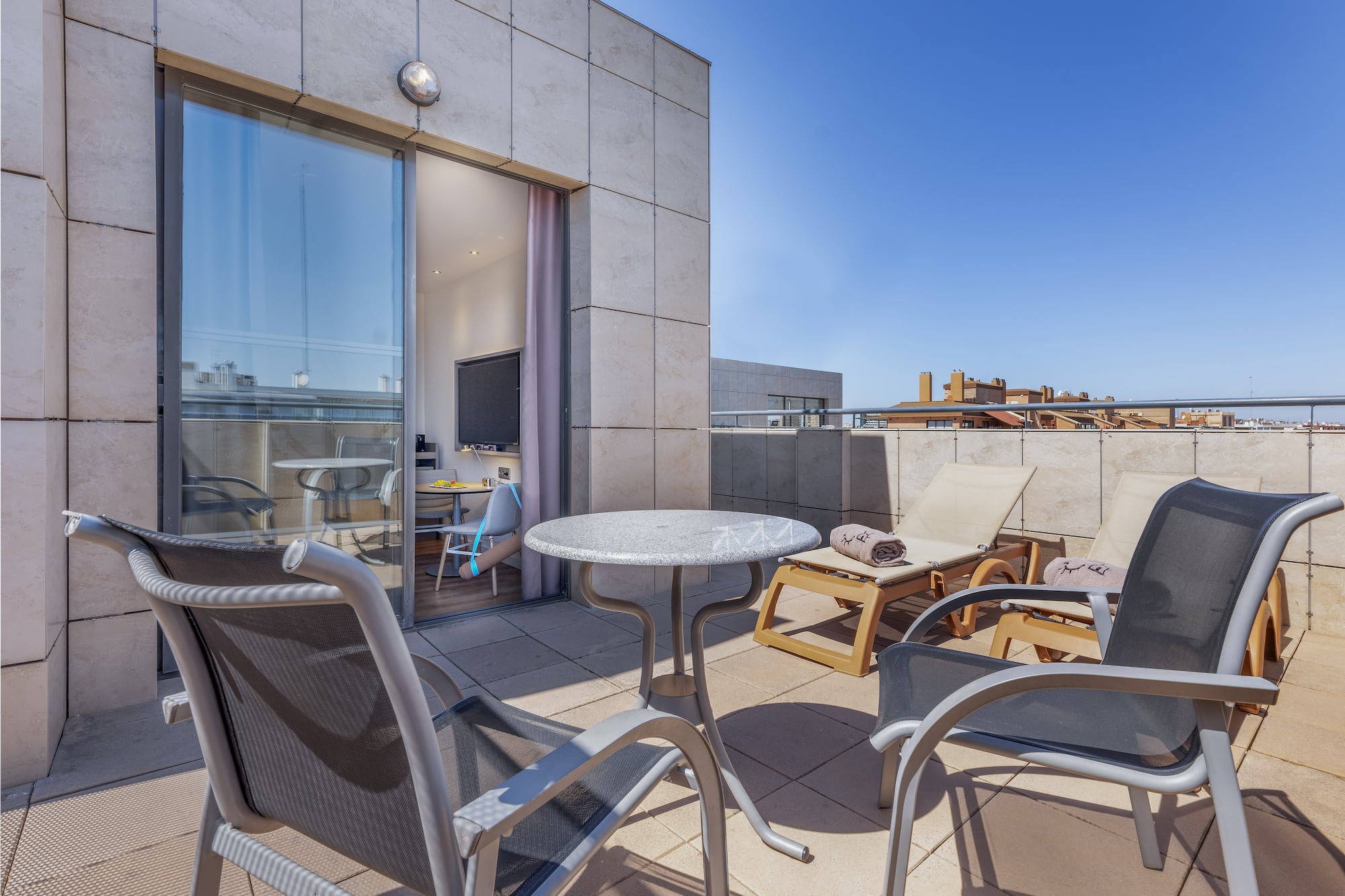 a patio with chairs and a table