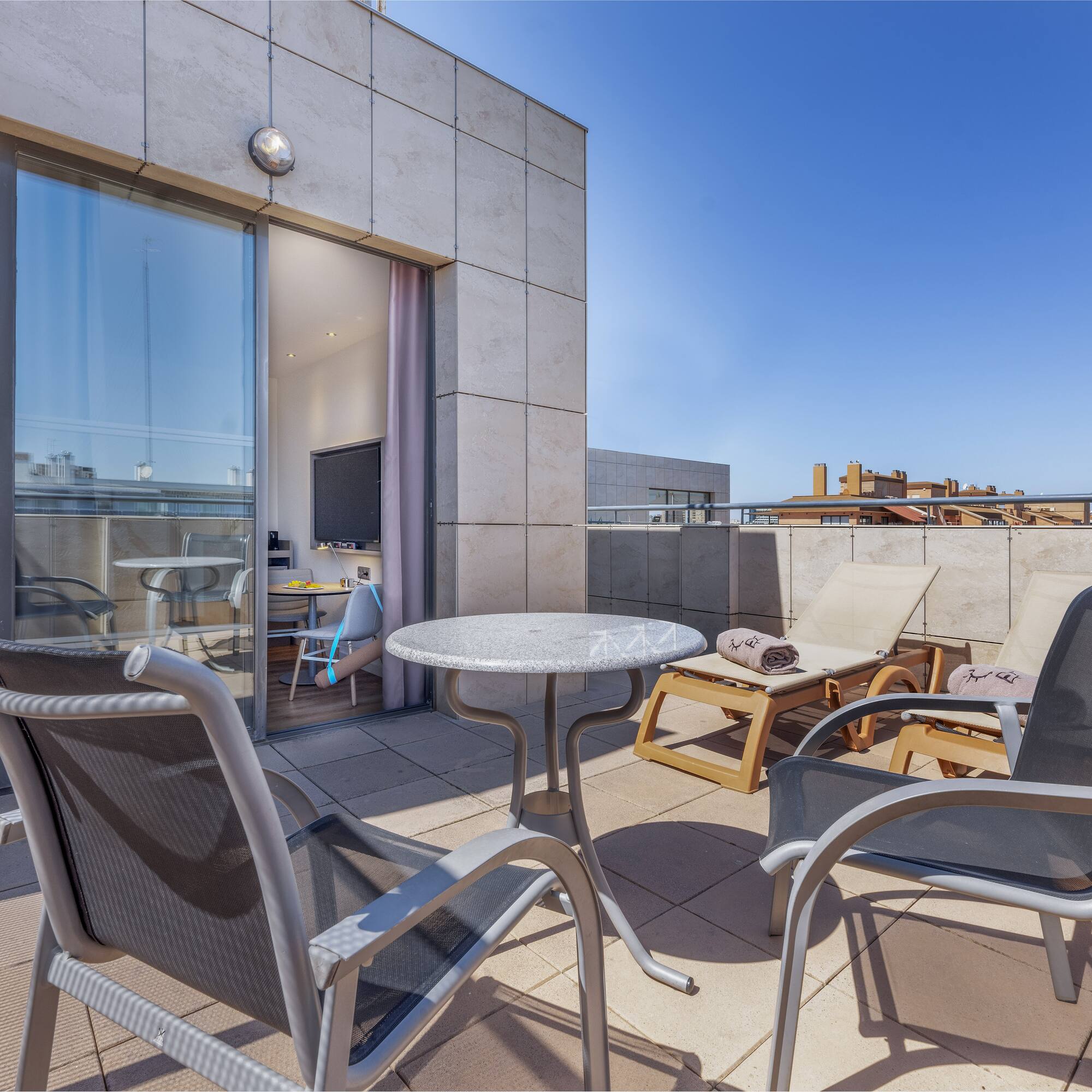 a patio with chairs and a table