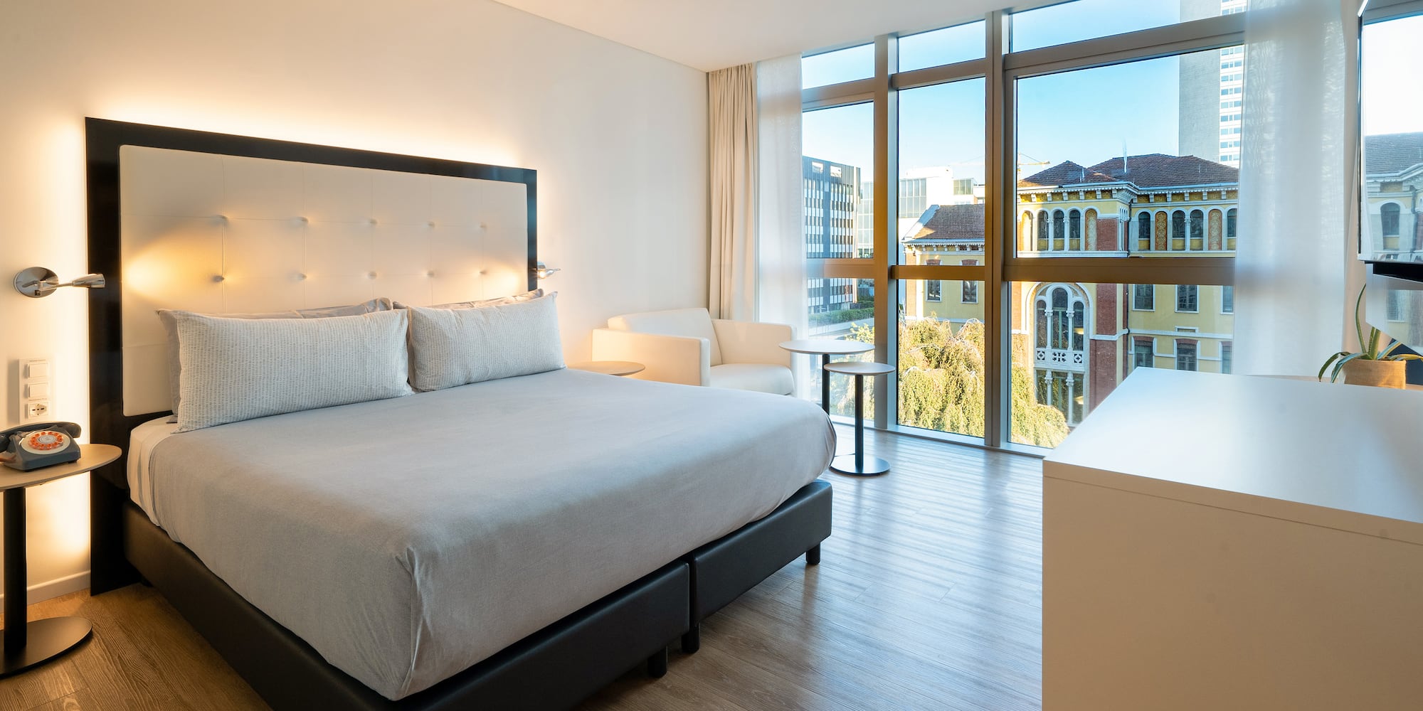 a bedroom with a bed and a table and chairs