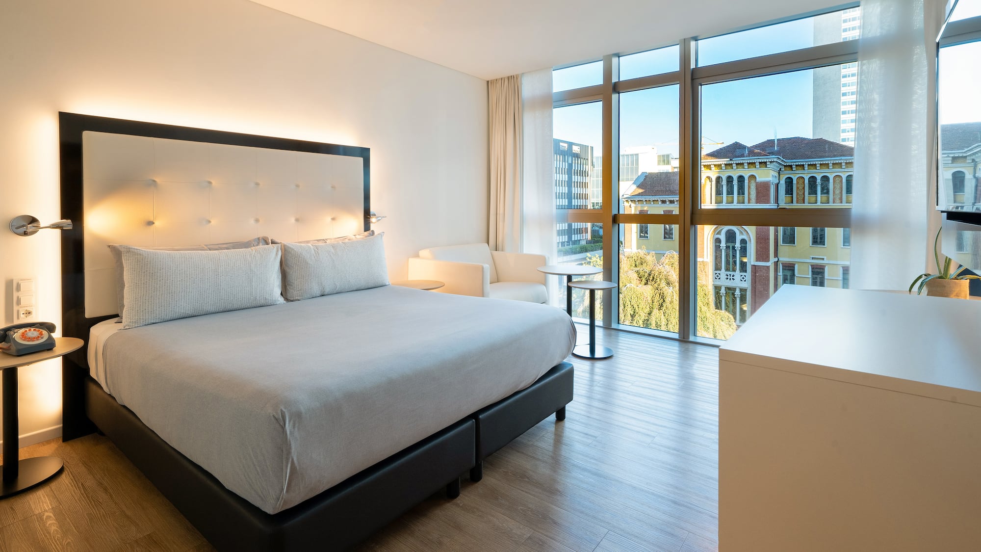 a bedroom with a bed and a table and chairs