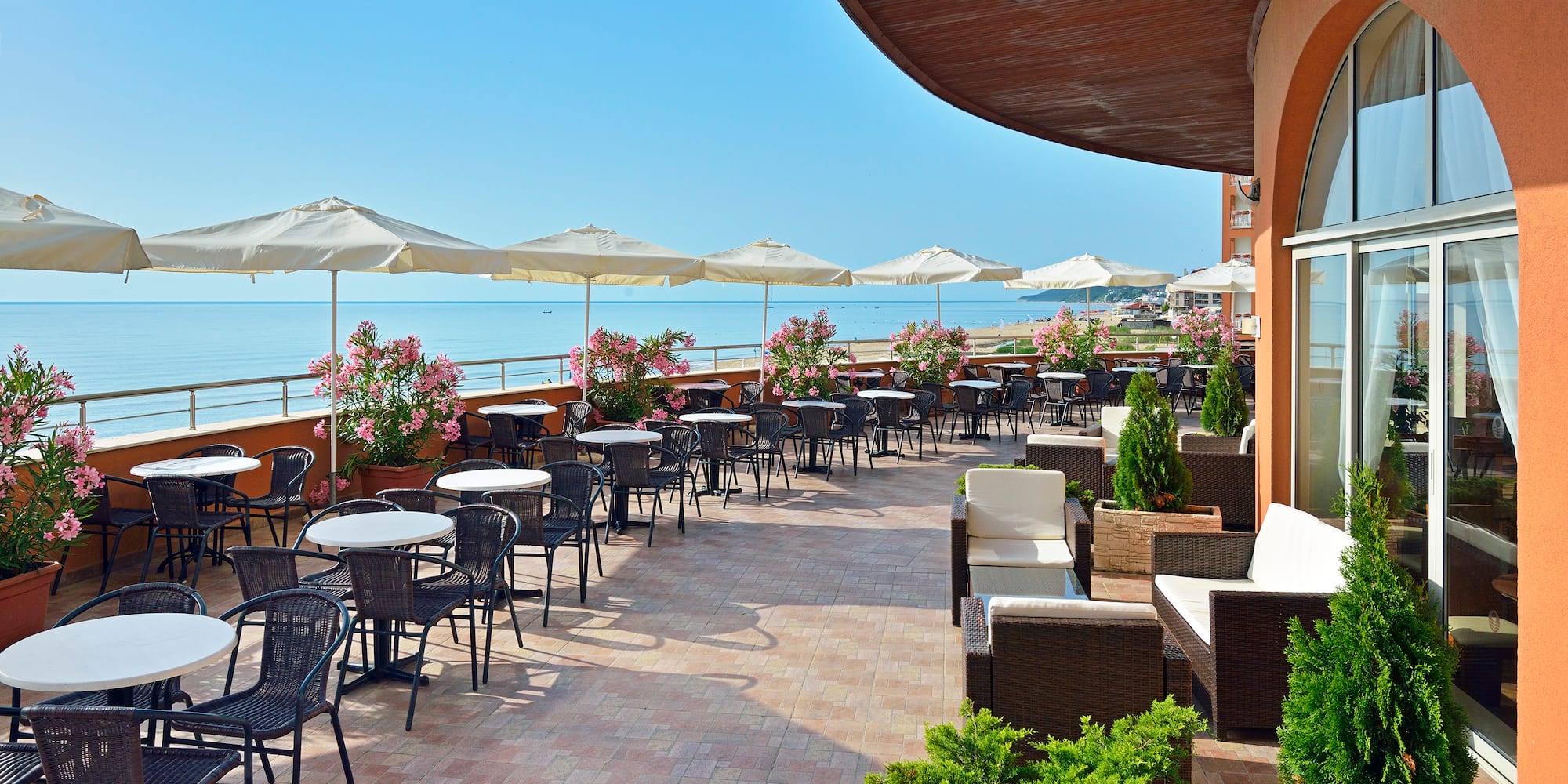 a patio with chairs and umbrellas