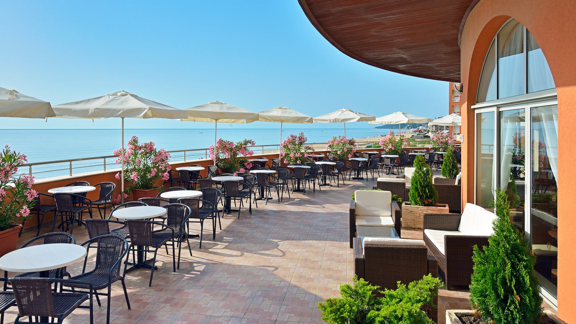 a patio with chairs and umbrellas