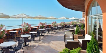 a patio with chairs and umbrellas