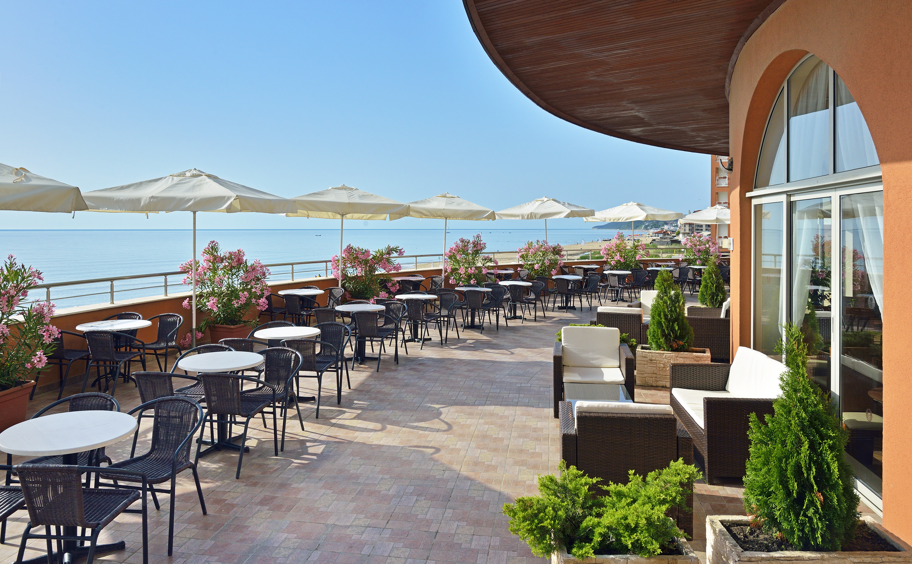 a patio with chairs and umbrellas