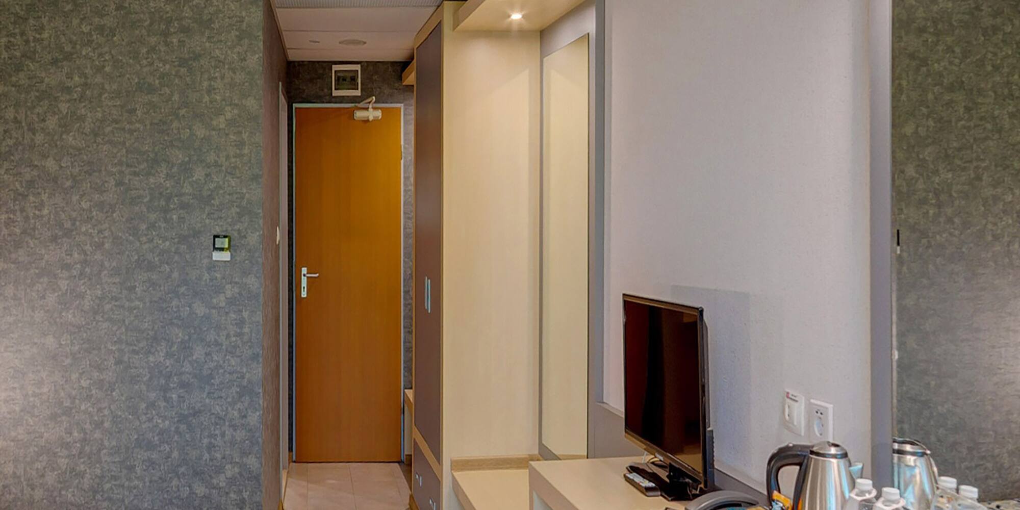 a room with a bed and a television