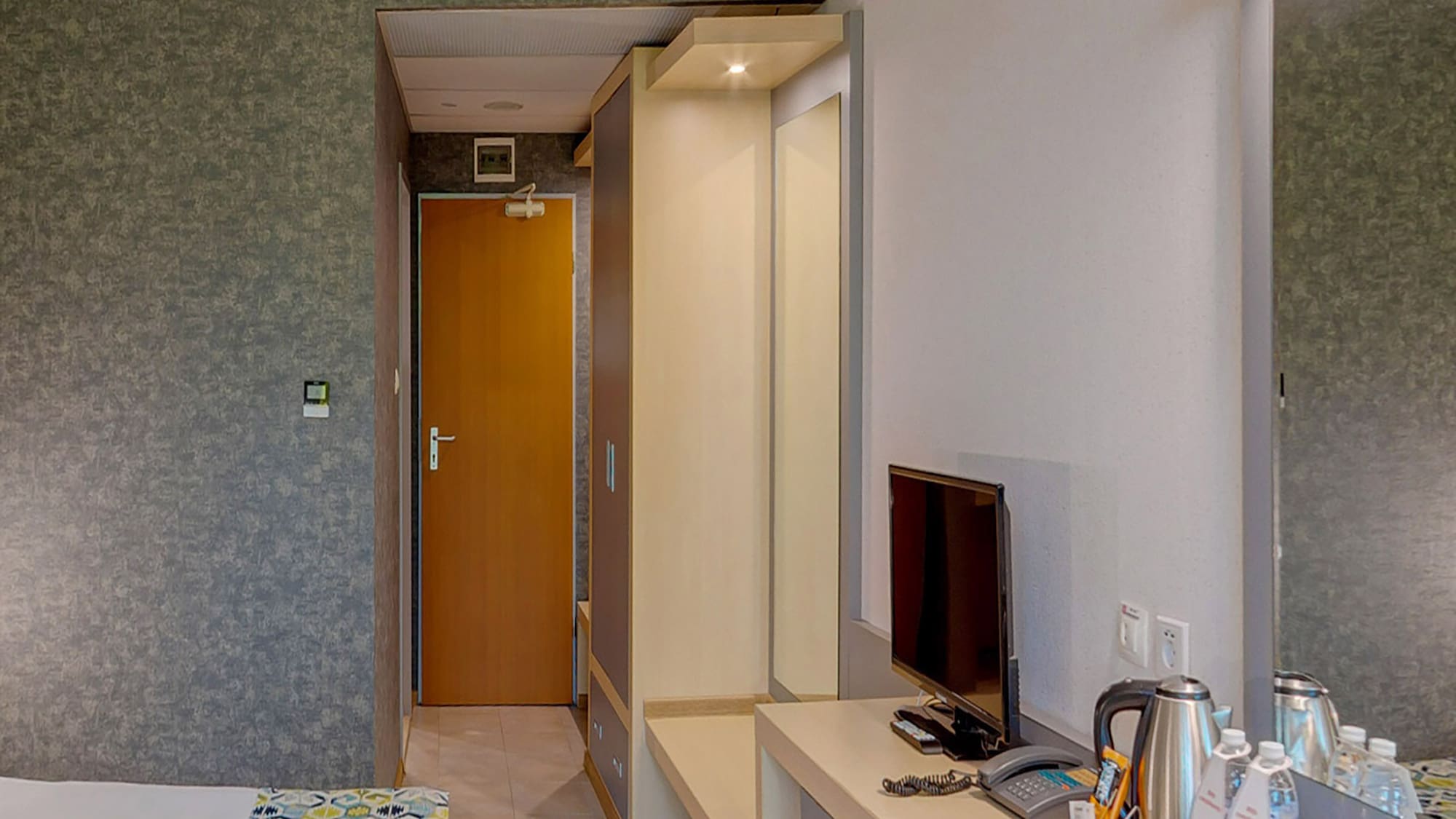 a room with a bed and a television