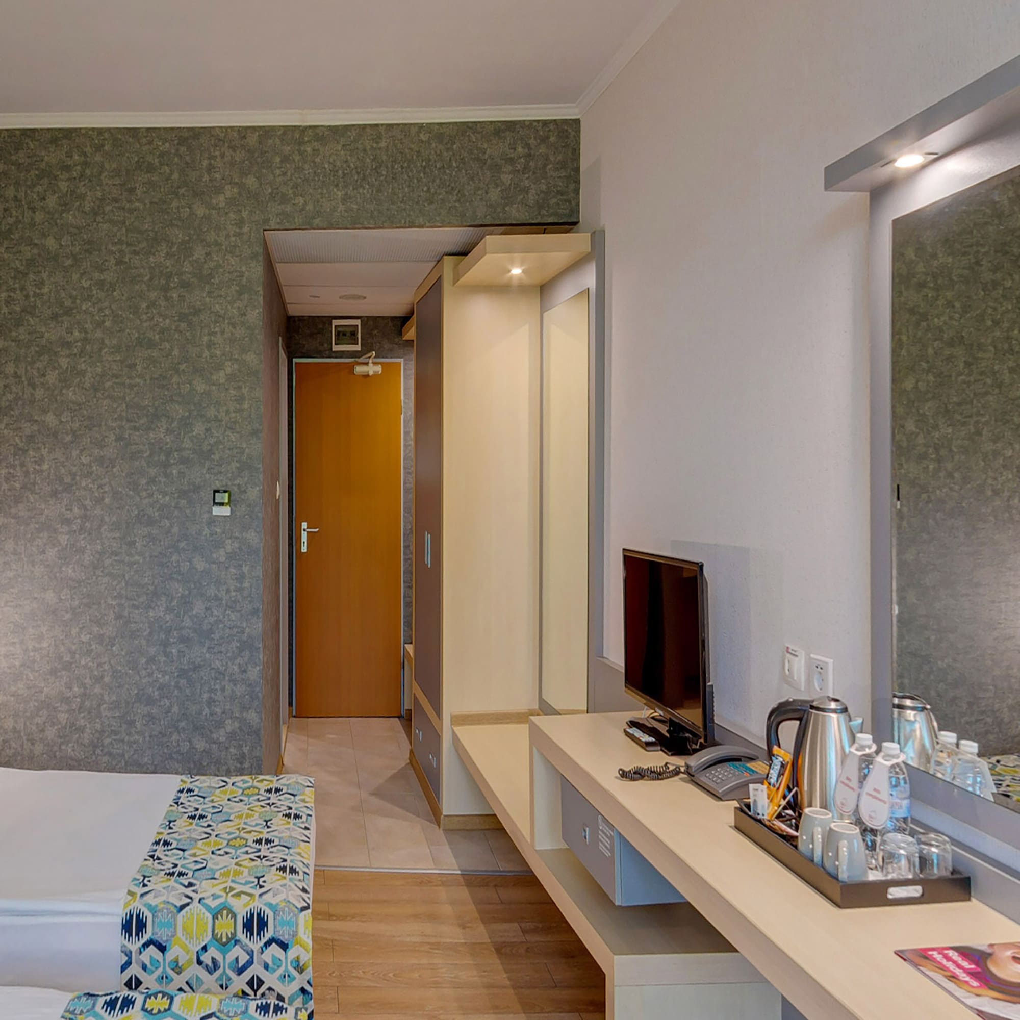 a room with a bed and a television