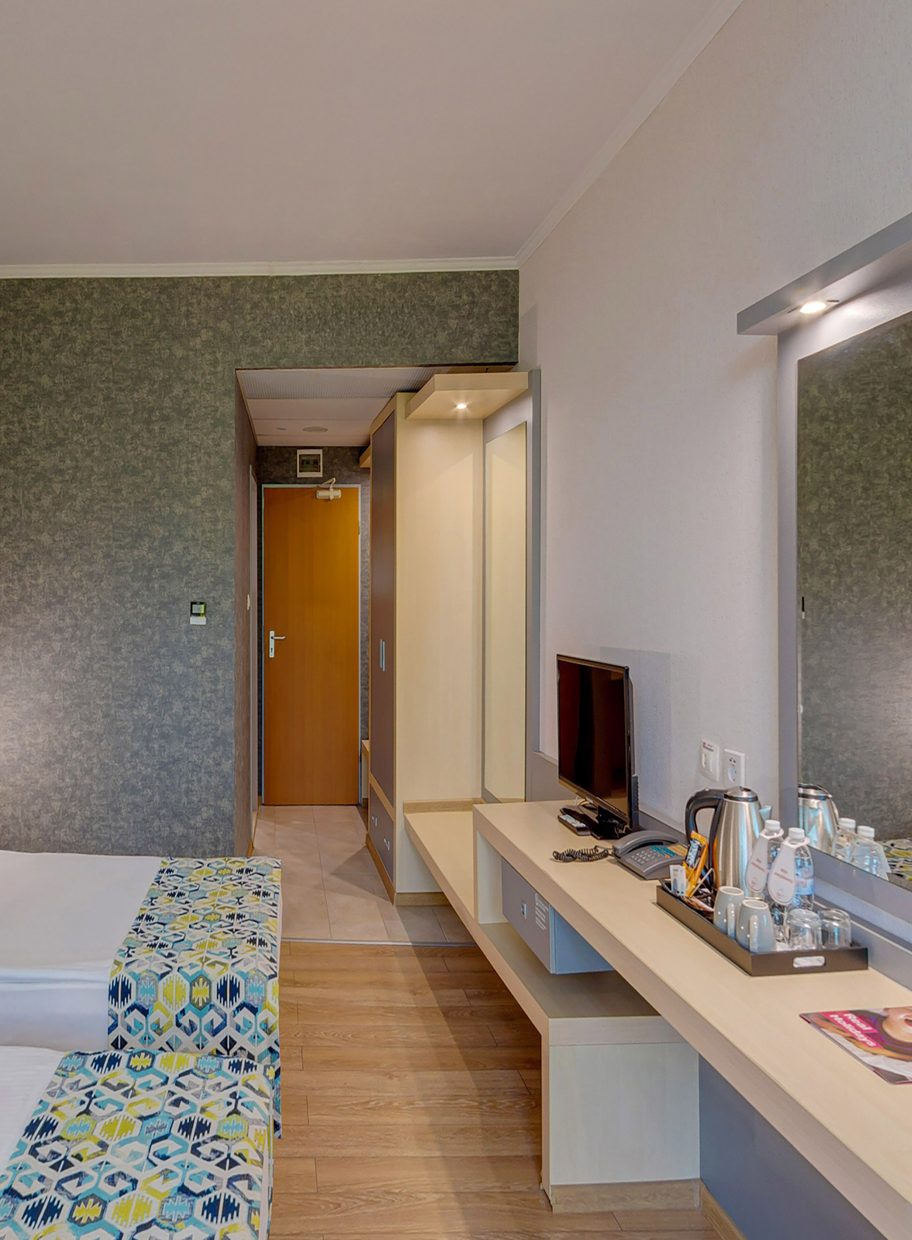 a room with a bed and a television