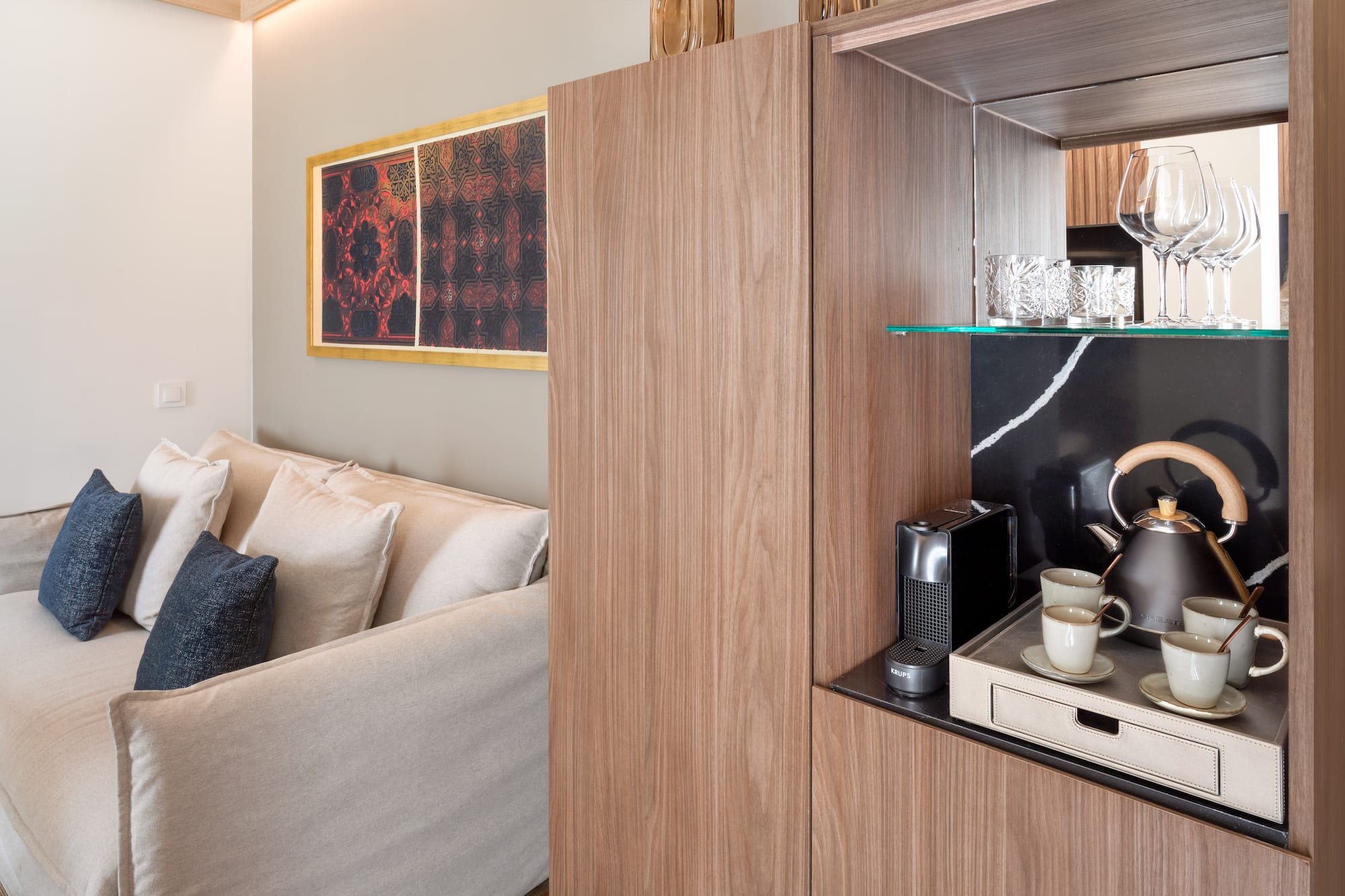 a room with a couch and a coffee maker