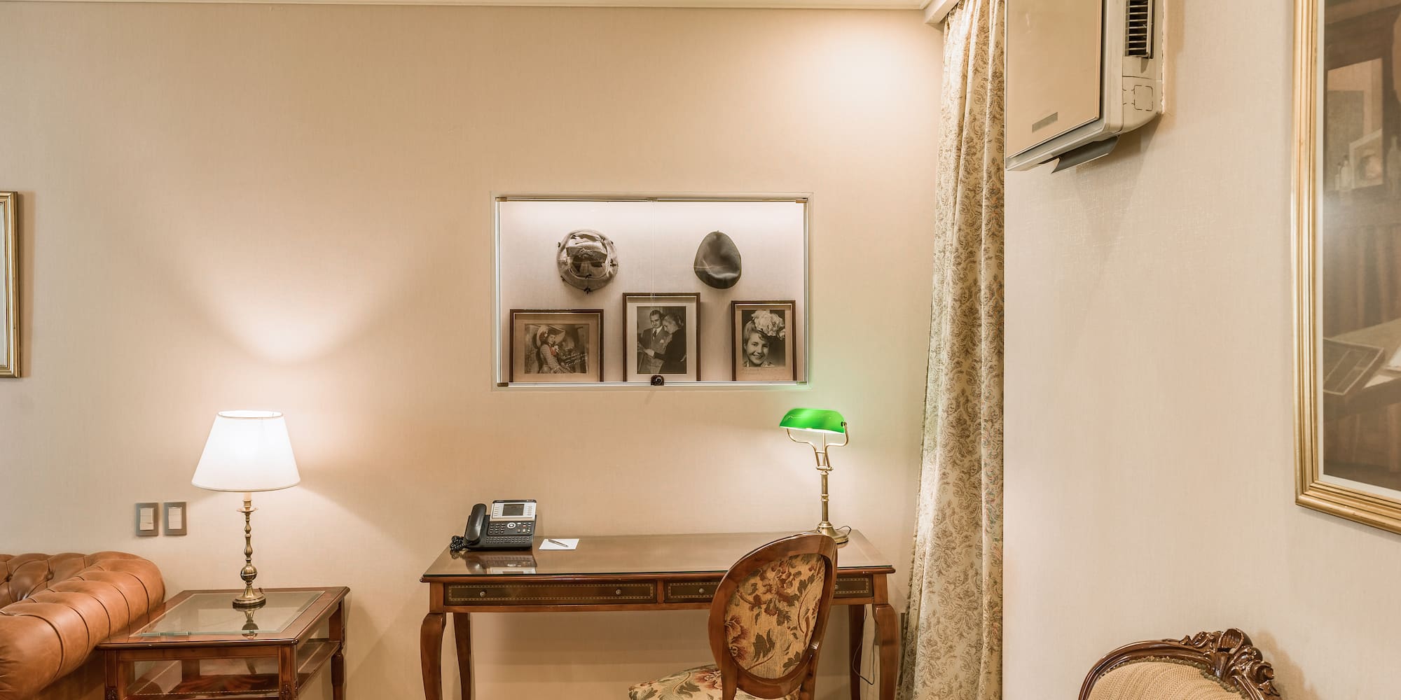 a room with a desk and chairs