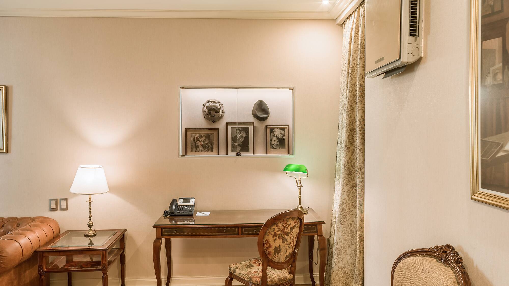 a room with a desk and chairs